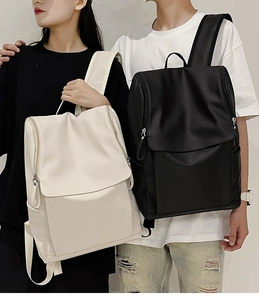 Minimalist nylon backpacks in black and cream worn by a couple for daily commuting