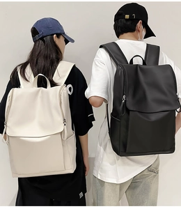 Rear view of models wearing large capacity black and cream travel backpacks with flap lids