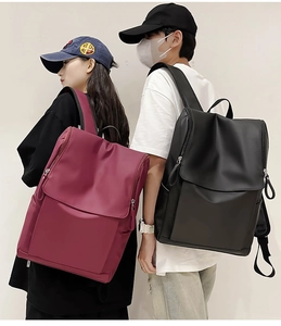 Waterproof nylon backpacks in burgundy and black with flap cover for travel use