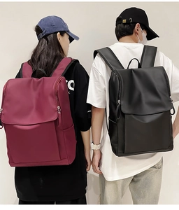 Detailed view of large capacity waterproof travel backpacks in burgundy and black colors