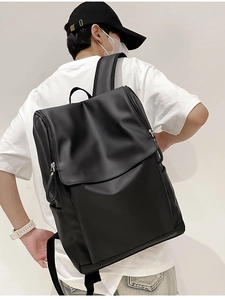 Close-up of high-capacity black backpack with double zipper and water-resistant fabric