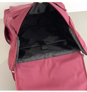Internal view of the red laptop backpack showing spacious compartment and padded protection