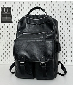 Detail view of black vintage leather backpack with multi-zipper pockets and buckle straps