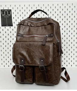 Detailed view of deep brown vintage leather backpack with dual buckle pockets and zippers