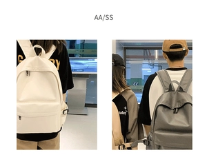 Detailed comparison of white and dark grey minimalist student backpacks with front zip pockets