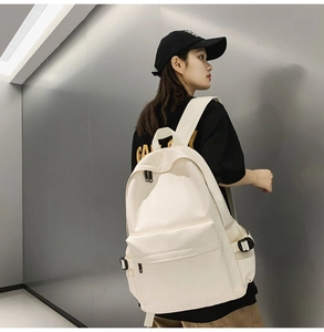 Side view of a soft cream college backpack showing wide straps and large capacity