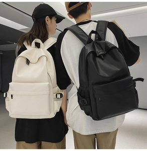Minimalist soft leather backpacks in black and cream worn by models for daily commute