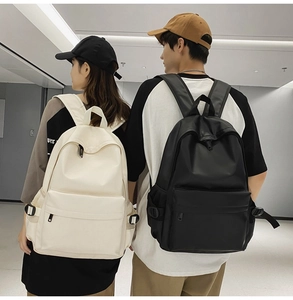 Minimalist waterproof nylon backpacks shown on male and female models in black and cream