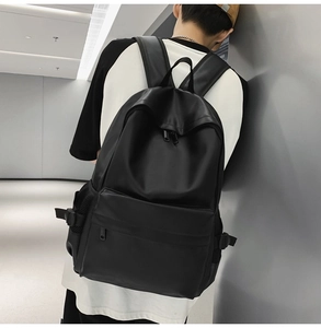 Detail of minimalist black matte backpack with adjustable side buckle and padded straps