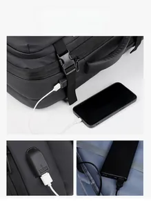 Detail of external USB charging port on a black business laptop backpack with phone connection