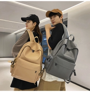 Detailed view of minimalist soft leather backpacks shown on models in khaki and dark grey