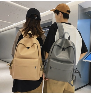 Dual view of khaki and grey minimalist backpacks with multi-pocket nylon construction