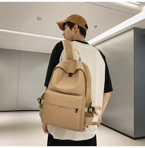 Detail of minimalist beige backpack with adjustable side buckles and durable nylon texture