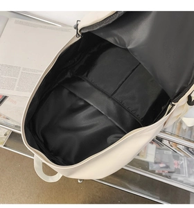 Top view of spacious cream backpack interior with large main compartment and laptop sleeve