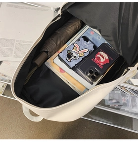 Detailed interior of a soft leather backpack showing large storage for laptop and umbrella