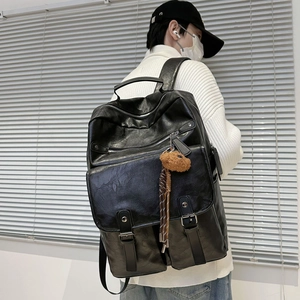 Large capacity black PU leather backpack for students featuring a cute bear keychain
