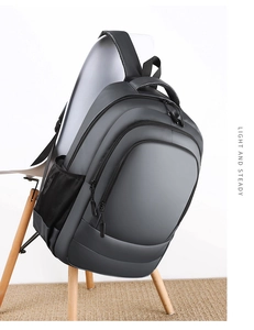 Water-resistant grey business backpack detail showing multiple storage layers and side mesh pocket