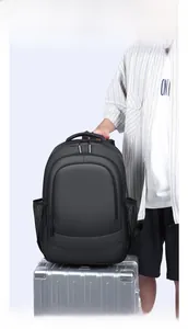 Detail of matte black business backpack attached to suitcase for easy travel transport