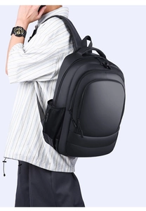 Close-up of matte black waterproof fabric and ergonomic handle on a business backpack