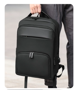 Close-up of black business backpack with external USB charging port and durable handle