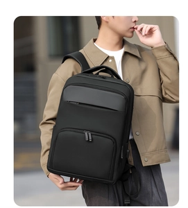 Ergonomic wide straps on a waterproof black business backpack for urban commuting