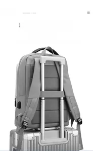 Business backpack with luggage strap and USB port fixed on silver suitcase handle