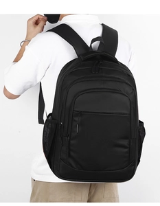 Detail of ergonomic padded shoulder straps on a large capacity black business backpack