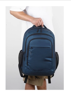 Detail of navy blue business backpack with sturdy handle and durable multi-pocket design