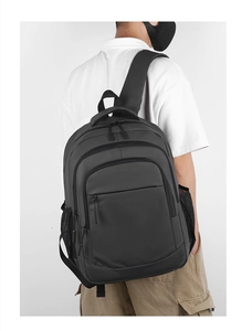 Detail view of large grey waterproof business backpack with multi-layer zipper compartments