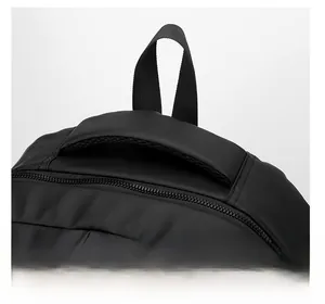 Detail of a large capacity laptop backpack showing padded handle and metal zippers