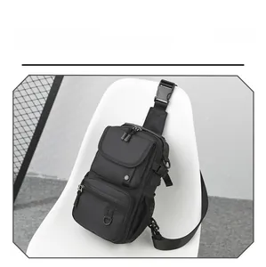 Detailed view of black tactical chest bag with multiple zippers and durable buckle
