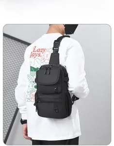 Rear view of model wearing a black tactical crossbody bag with adjustable wide strap