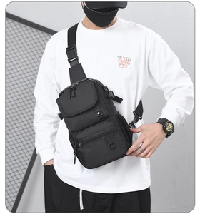 Detail of black waterproof tactical chest bag with functional pockets and adjustable strap