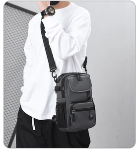 Detailed side view of grey tactical shoulder bag with black mesh pocket and strap