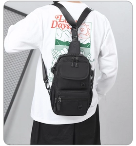 Close-up of tactical nylon chest bag with adjustable strap and multiple zip pockets
