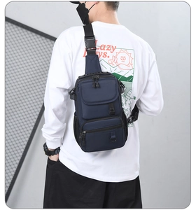Detailed view of a navy blue multifunctional crossbody chest bag with adjustable strap