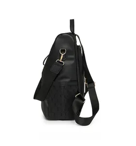 Side view of black anti-theft backpack showing geometric texture and gold metal hardware