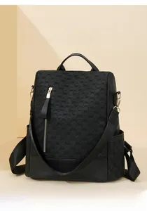 Detail view of anti-theft backpack with textured surface and gold zipper accents