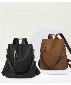 Detail of water-resistant anti-theft backpacks in black and brown with woven texture