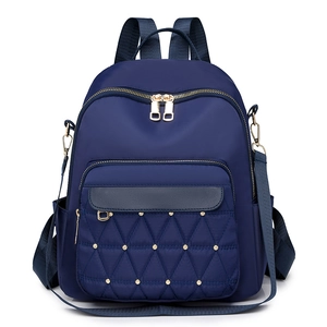 Navy blue Oxford cloth backpack with quilted triangle pattern and gold rivets for women