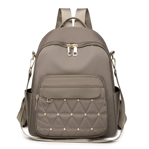 Women's khaki Oxford nylon backpack with geometric quilted pockets and gold rivets