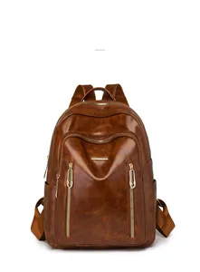 Detail of dark brown vintage leather backpack with golden zippers and lychee texture