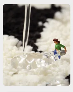 Macro detail of thick absorbent fiber mat showing rapid water absorption with mini figures