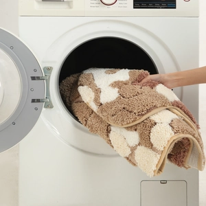 Washable thick moss rug being placed into a washing machine for easy cleaning and care