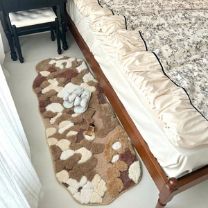 Irregular moss-style plush bedroom rug with floral pattern in warm earth tones