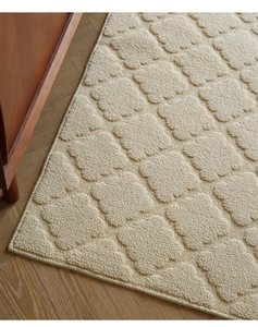 Macro shot of 3D embossed petal pattern on soft cream-colored indoor floor mat