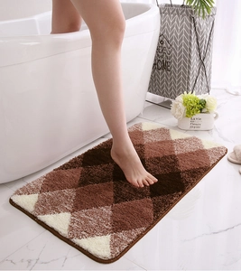 Close-up of geometric flocking bath mat with thick soft texture and non-slip backing