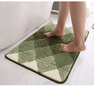 Close-up of green and white diamond pattern flocking bath mat with soft tufted texture