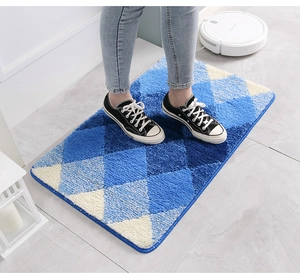 Macro detail of soft flocked bath mat with blue argyle pattern and durable hemmed edges