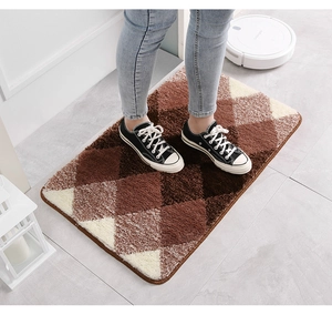 Close-up of geometric gradient flocked bathroom mat with dense pile and neat edge locking